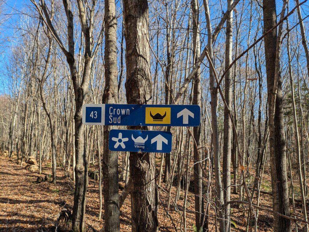 Signs on a ski trail in the fall:
"43 Crown Sud"
"Accueil Viking"